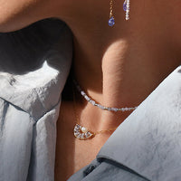 Close-up of a woman wearing elegant earrings with a soft focus on her face.
