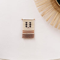 Homeware_ Maasai beaded wall hanging using recycled thread in neutral colour palette. Featured next to People of the suns mirror. 