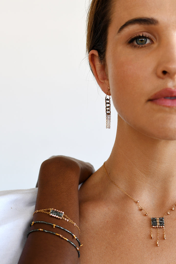 Christi Steyn and Lulutho Mntnintshi wearing Sidai Designs timeless African inspired 14kt gold filled semi precious jewelry - including beaded earrings with chain tassels, beaded wire necklace with Swarovski crystals and simple beaded bracelets.