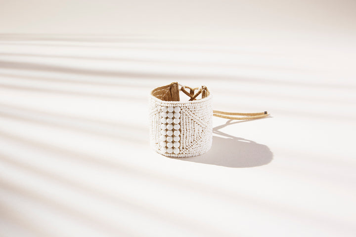 Modern African white beaded statement leather bracelet cuff with adjustable closure.