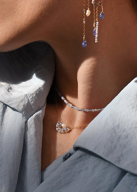 Close-up of a woman wearing elegant earrings with a soft focus on her face.