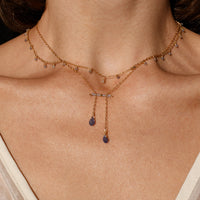 Necklace with small tanzanite stones worn by a person