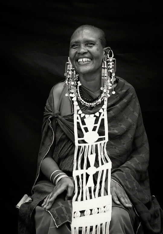 Beautiful black and white portarit of Maasai lady, Nemasi adorned in traditional statement earrings and rare beaded wedding necklace. 