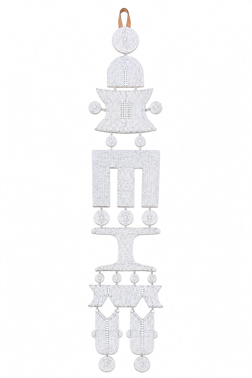 A white beaded hanging ornament with a geometric, tiered design and a small tan hanging loop at the top, shown against a plain white background.