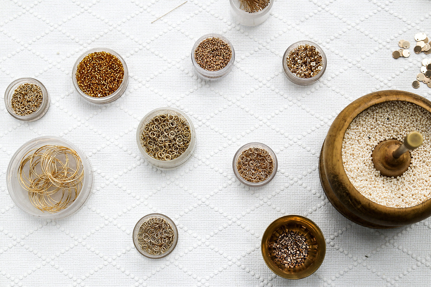 Bowls of 14kt gold filled fastening and beads used to make jewelry.