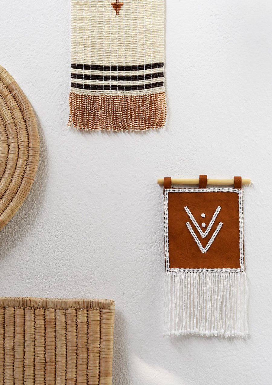 Homeware_Beaded Leather Wall Hanging Handmade by Maasai women. Featured here with People of the Suns natural mask.