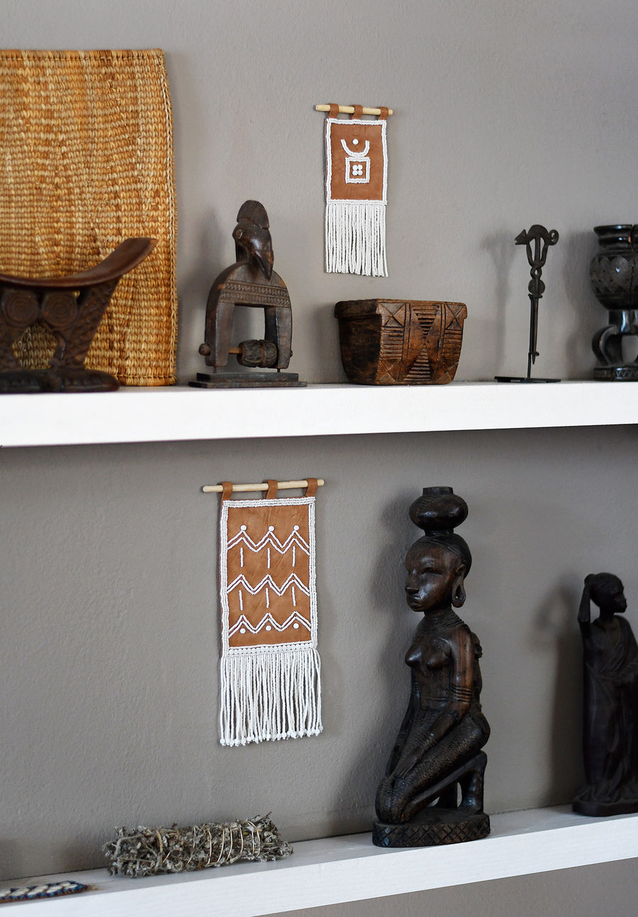 Homeware_ Maasai beaded zig zag wall hanging. Embroidered leather in white beads. Shot at Design Afrika.